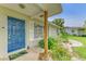 Inviting front entrance with a vibrant blue door and decorative landscaping at 237 Saxon Cir, Venice, FL 34293