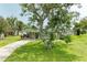 Charming single-story home with a well-manicured lawn and mature shade tree at 237 Saxon Cir, Venice, FL 34293