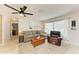 Inviting living room featuring a plush sofa, leather recliner, and ample natural light at 237 Saxon Cir, Venice, FL 34293
