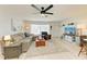 Bright living room with comfortable seating, stylish rug, and a modern ceiling fan at 237 Saxon Cir, Venice, FL 34293