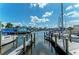 Marina view of boats, docks, waterfront structures, and clear blue skies with fluffy clouds at 237 Saxon Cir, Venice, FL 34293