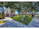 Charming park with mature trees, benches, and a historic building in the background at 237 Saxon Cir, Venice, FL 34293