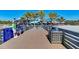 Pier view showcasing fishing rules, a trash receptacle, and distant beachfront buildings at 237 Saxon Cir, Venice, FL 34293