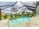 Inviting in-ground pool is enclosed with a screened cage and bordered by lush landscaping at 237 Saxon Cir, Venice, FL 34293