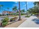 Street view with lush landscaping, palm trees, and well-maintained sidewalks at 237 Saxon Cir, Venice, FL 34293