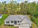 An aerial view of this home shows a metal roof and landscaping, backing onto a natural waterway at 2523 Hagerick Ln, North Port, FL 34288
