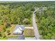 Beautiful home with a metal roof surrounded by lush greenery and trees offering privacy and a serene setting at 2523 Hagerick Ln, North Port, FL 34288