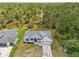 Aerial view of home with a metal roof and landscaping situated next to a tranquil waterway at 2523 Hagerick Ln, North Port, FL 34288