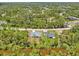 Aerial view of two properties surrounded by lush trees, showing their positioning and neighborhood layout at 2523 Hagerick Ln, North Port, FL 34288