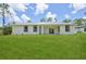 Spacious backyard with lush green lawn surrounding a modern single-story home at 2523 Hagerick Ln, North Port, FL 34288