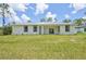Expansive backyard featuring lush green grass and a well-manicured lawn with beautiful landscaping at 2523 Hagerick Ln, North Port, FL 34288
