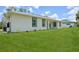 Lush green backyard with well-maintained lawn surrounding a modern, single-story home at 2523 Hagerick Ln, North Port, FL 34288