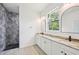 Modern bathroom featuring a walk-in shower and double vanity at 2523 Hagerick Ln, North Port, FL 34288