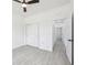 Bright bedroom features a ceiling fan, closet space, and neutral colored tile flooring throughout at 2523 Hagerick Ln, North Port, FL 34288