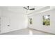 Comfortable bedroom featuring wood-look tile floors and two windows for natural light at 2523 Hagerick Ln, North Port, FL 34288