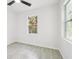 Bright bedroom with a ceiling fan, light walls, wood-look flooring and a window to the outside at 2523 Hagerick Ln, North Port, FL 34288