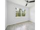 Bedroom featuring wood-look tile floor, ceiling fan, and large window view at 2523 Hagerick Ln, North Port, FL 34288