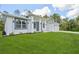 Modern new construction home featuring a well-maintained lawn and stylish architectural details at 2523 Hagerick Ln, North Port, FL 34288