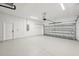 Spacious two car garage with bright lighting, door to exterior, and painted floor at 2523 Hagerick Ln, North Port, FL 34288