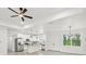 Bright, open kitchen with stainless steel appliances, modern lighting and an island with granite countertops at 2523 Hagerick Ln, North Port, FL 34288