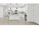 Modern kitchen with white cabinets, stainless steel appliances, granite countertops, and an island at 2523 Hagerick Ln, North Port, FL 34288