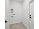 This laundry room features tile flooring and updated hookups for your washer and dryer at 2523 Hagerick Ln, North Port, FL 34288
