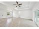 Bright, open living room with recessed lighting, a ceiling fan, and sliding glass doors at 2523 Hagerick Ln, North Port, FL 34288