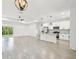 Bright, open-concept living space featuring modern kitchen with stainless appliances and island, and tile flooring at 2523 Hagerick Ln, North Port, FL 34288