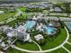 Aerial view of a community pool and amenities in a residential area at 2586 Wild Cherry Path, Sarasota, FL 34240