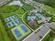 Aerial view showcasing community amenities including pools, tennis courts, and playground at 2586 Wild Cherry Path, Sarasota, FL 34240