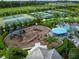 Aerial view of community playground, tennis courts, and swimming pools at 2586 Wild Cherry Path, Sarasota, FL 34240