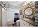 Nautical-themed bathroom with fish wallpaper, rope mirror, and modern fixtures at 2586 Wild Cherry Path, Sarasota, FL 34240