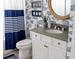 Stylish bathroom with a rope-trimmed mirror, coastal wallpaper, and modern vanity at 2586 Wild Cherry Path, Sarasota, FL 34240