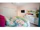 Comfortable bedroom with tropical bedding, a large closet, and soft pink walls at 2586 Wild Cherry Path, Sarasota, FL 34240