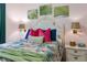 Inviting bedroom with plush bedding, ambient lighting, and tropical artwork at 2586 Wild Cherry Path, Sarasota, FL 34240