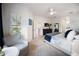 Spacious and well-lit bedroom with a sitting area, ensuite bathroom, and large dresser at 2586 Wild Cherry Path, Sarasota, FL 34240