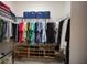 Organized walk-in closet featuring clothing racks, shelves, and storage bins for optimal storage at 2586 Wild Cherry Path, Sarasota, FL 34240