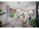 Open-concept dining area with hardwood floors that transition to a modern kitchen at 2586 Wild Cherry Path, Sarasota, FL 34240