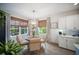 Dining area with light hardwood flooring, a modern chandelier, and lots of natural light at 2586 Wild Cherry Path, Sarasota, FL 34240