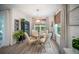 Dining area with light hardwood flooring, a modern chandelier, and lots of natural light at 2586 Wild Cherry Path, Sarasota, FL 34240