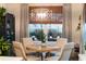 Bright dining room with modern light fixture and views of the landscaped yard, creating an inviting atmosphere at 2586 Wild Cherry Path, Sarasota, FL 34240