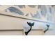 Entryway detail showcases charming whale tail hooks under a decorative shelf at 2586 Wild Cherry Path, Sarasota, FL 34240
