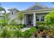 Charming single-Gathering home featuring a covered entrance, paver walkway, and lush landscaping at 2586 Wild Cherry Path, Sarasota, FL 34240