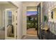 A view from the foyer past the open front door with decoratively papered accent wall at 2586 Wild Cherry Path, Sarasota, FL 34240