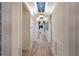 Bright hallway with tray ceilings, modern light fixtures, and views into the living room at 2586 Wild Cherry Path, Sarasota, FL 34240