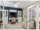 Bright home office with a white desk, cabinets, ceiling fan and cozy seating area with window views at 2586 Wild Cherry Path, Sarasota, FL 34240
