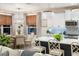 Open-concept kitchen and dining area featuring pendant lights, modern appliances, and elegant finishes at 2586 Wild Cherry Path, Sarasota, FL 34240