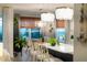 Kitchen island with seating and light fixtures overlooking a living area at 2586 Wild Cherry Path, Sarasota, FL 34240