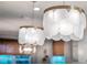 Close up of decorative light fixtures hanging over a kitchen island at 2586 Wild Cherry Path, Sarasota, FL 34240