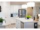 Well-lit kitchen features white cabinetry, stainless steel appliances, and a kitchen island with bar seating at 2586 Wild Cherry Path, Sarasota, FL 34240